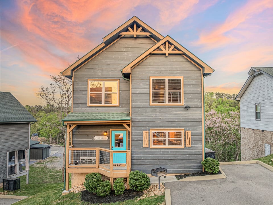 Modern craftsman cabin with bright entry, porch, and serene wooded views
