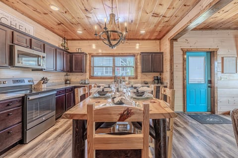 Rustic cabin kitchen with stainless appliances & family-size table