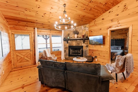 Enjoy breathtaking mountain views while relaxing in the cozy living room of this picturesque retreat.