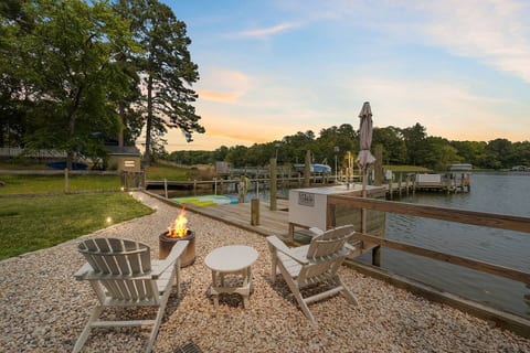 Relax by the fire with stunning creek views. Perfect spot to unwind, sip a drink, and enjoy peaceful waterfront evenings at Crazy Whays Retreat.