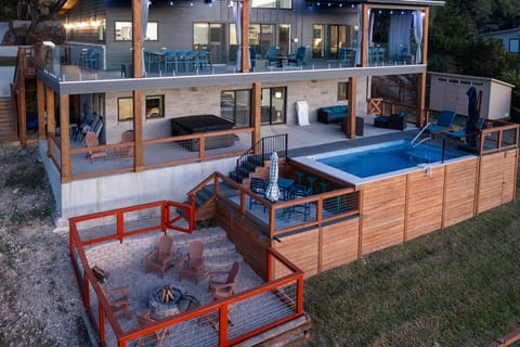 Features a pool with a swim up bar, hot tub, fire pit lounge, and expansive hangout spaces - ideal for relaxing days and memorable nights with friends and family