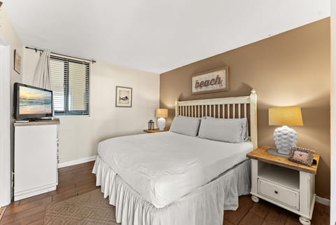 Cozy primary bedroom featuring a comfortable king bed and coastal-inspired décor.