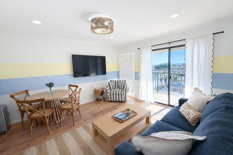 Bright and open living room with brand new 65" TCL Roku Smart TV. Stream your favorite shows or watch cable TV. Ocean views from the sofa!