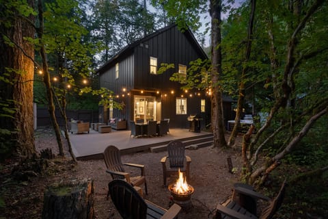 Fire pit evenings under the trees — this modern cabin on Mt. Hood comes with a private hot tub, gas fire pit, and string-lit deck for dinners al fresco. Paired with a second home next door, it's the perfect basecamp for group getaways.