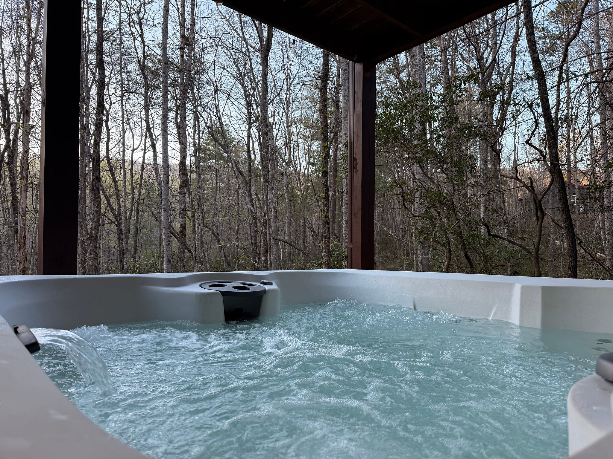 Secluded forest-view hot tub on covered deck—relax and unwind