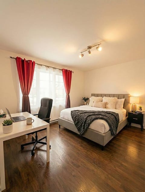 Settle into this cozy, stylish bedroom. Enjoy a restful night's sleep and a complete workspace with a desk, perfect for remote work.