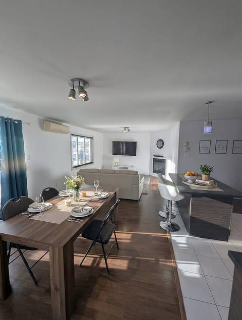 Bright and spacious open-concept living! Dine at the beautiful wood table, grab a drink at the island, and unwind in the cozy living area with a fireplace.