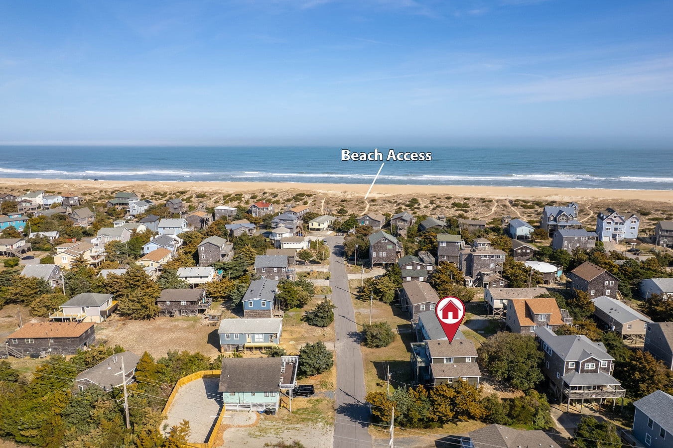 Aerial view of the neighborhood near the coast, showing nearby homes & beach access