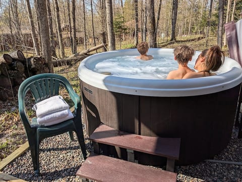 Private hot tub surrounded by trees right outside for your enjoyment