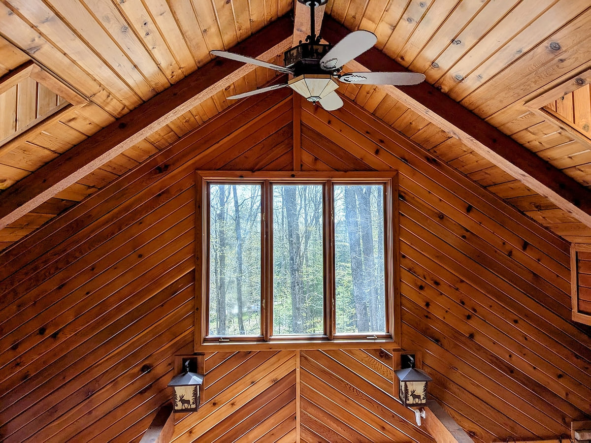 View of forest and vaulted ceilings from upper level above main level living area