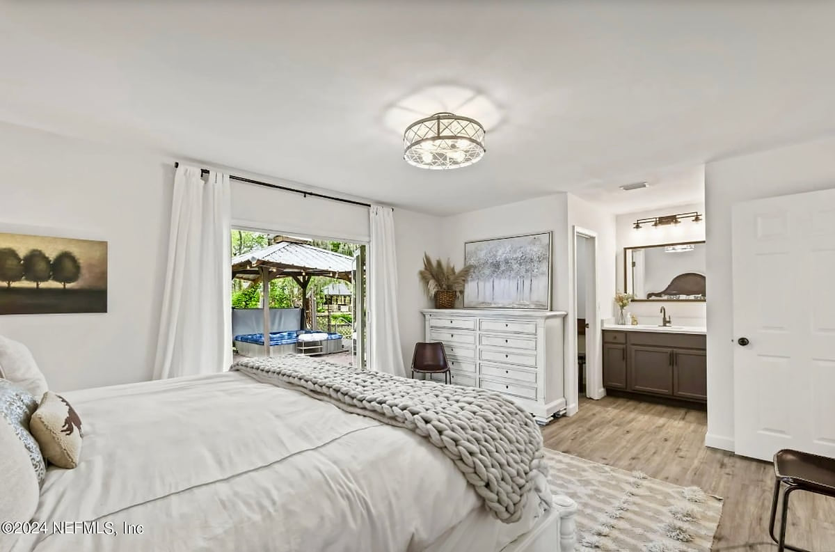 King bedroom with private bathroom opens up to the wide back deck with loungers and adult hot tub! Includes a large walk in closet.