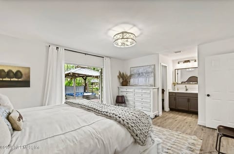 King bedroom with private bathroom opens up to the wide back deck with loungers and adult hot tub! Includes a large walk in closet.