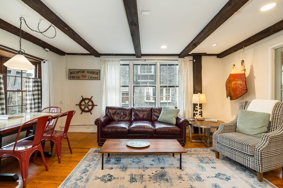 Living Room: Bright space with nautical charm, leather couch, and dining for four! Perfect for relaxing!