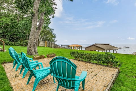 Private deck with outdoor furniture and bay views at Bayfront Bliss Gulf Breeze pet-friendly waterfront vacation home