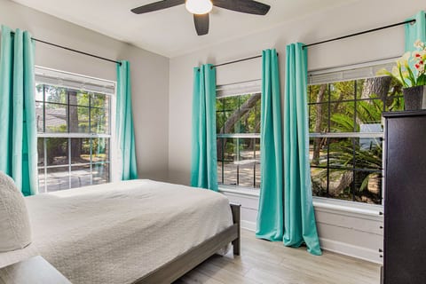 Coastal bedroom with comfortable bedding at Bayfront Bliss Gulf Breeze bayfront house near Pensacola Beach Florida