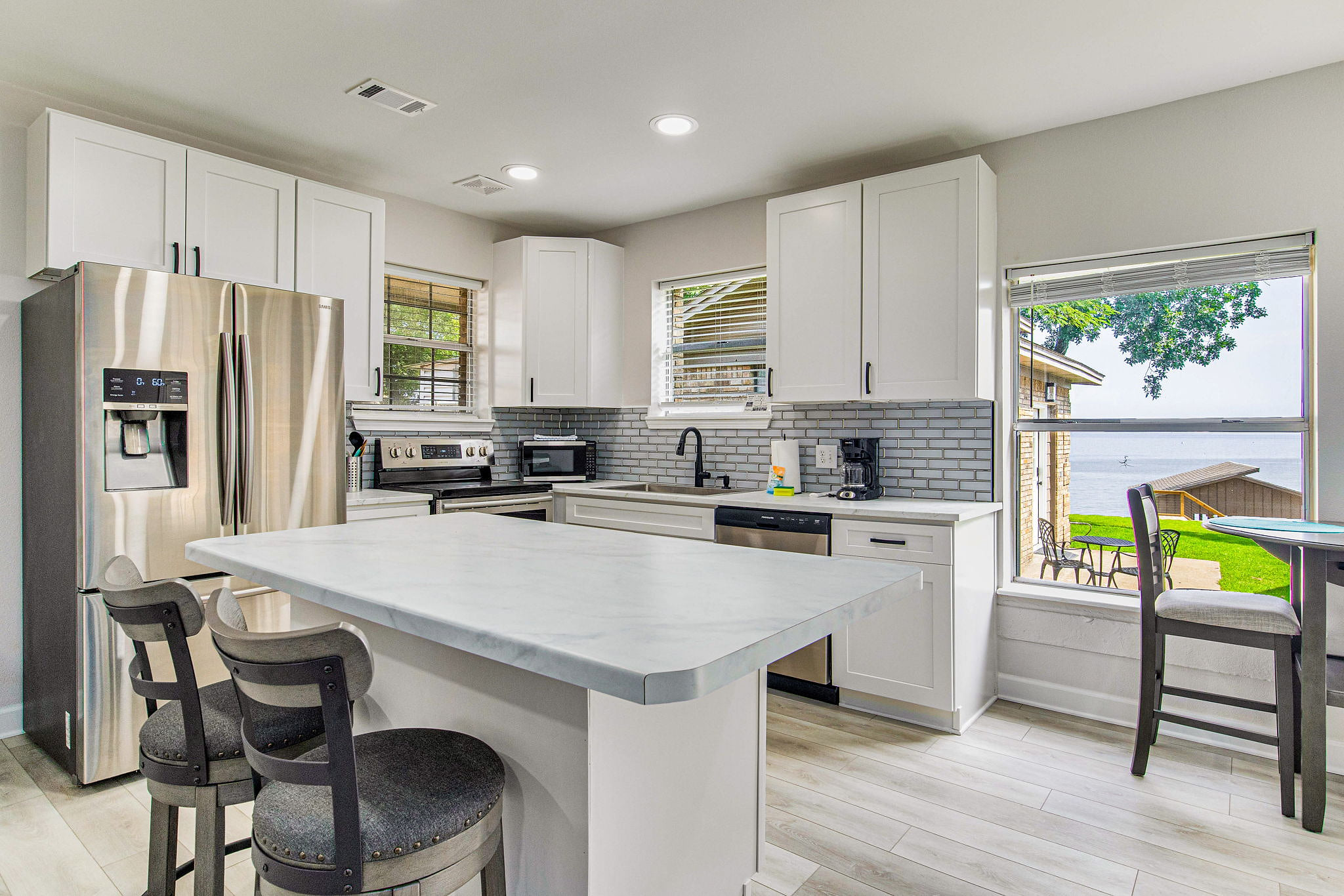 Kitchen with subway tile backsplash and stainless appliances at pet-friendly Gulf Breeze bayfront vacation rental home