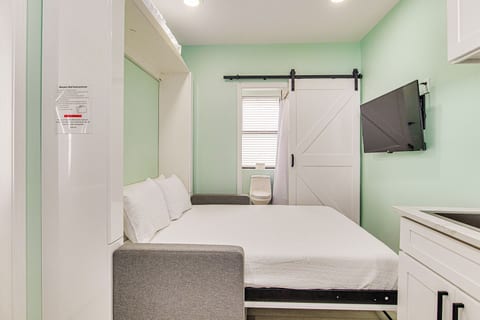 Comfortable murphy bed extended with flat screen TV