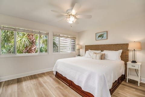 Primary bedroom with queen bed and coastal décor at Needle Rush Point waterfront condo