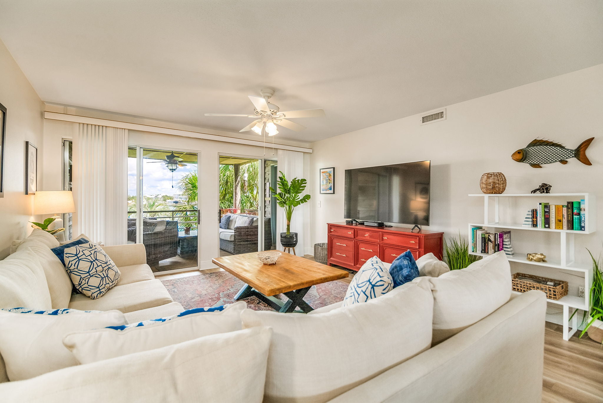 Bright open living room with balcony access and river views at Perdido Key waterfront condo