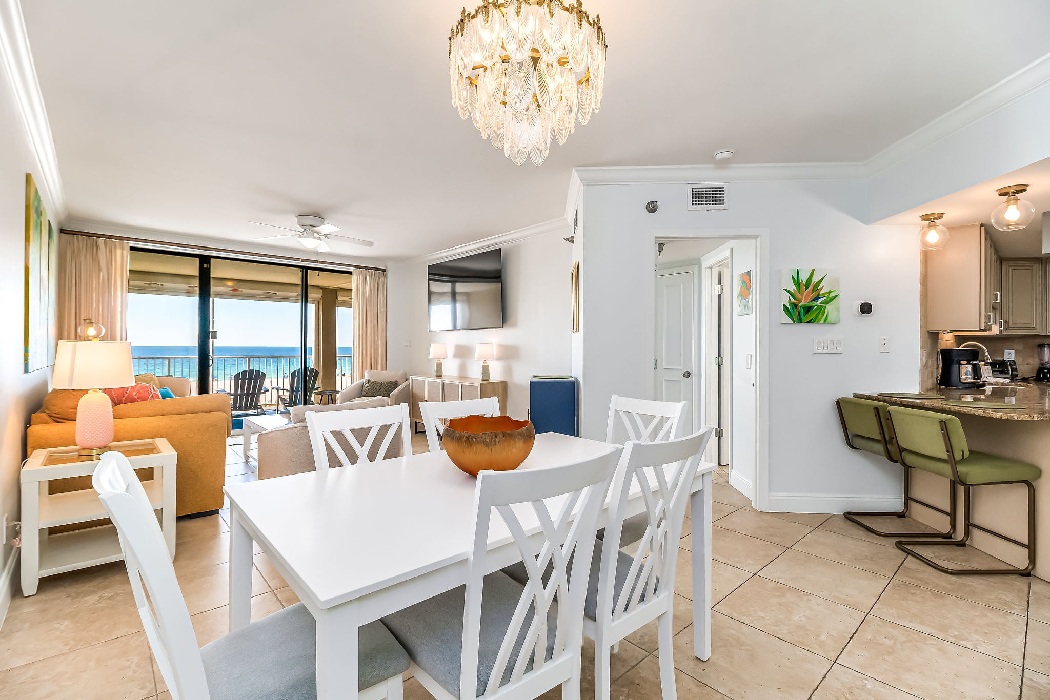 Open-concept living and dining with crystal chandelier at renovated Orange Beach vacation rental