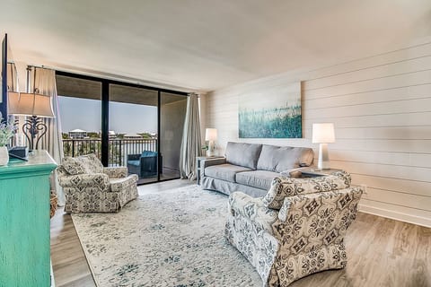 Living room with comfortable seating and Old River views at Wind Drift Orange Beach vacation condo