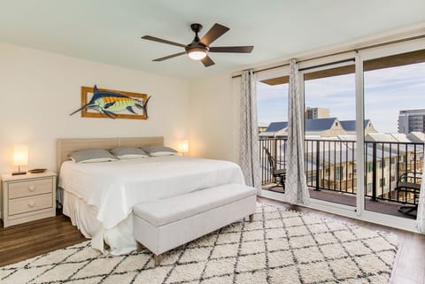 Primary Bedroom features King bed with comfortable linens, ensuite bathroom with tub/shower combination, and beautiful Old River and Ono Island bay views through large windows.