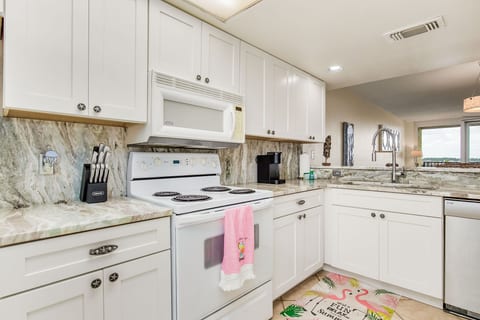 Fully equipped kitchen with white cabinets and granite counters at Wind Drift Orange Beach waterfront rental