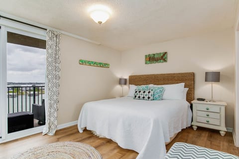 Primary bedroom with king bed and stunning Old River views at Wind Drift Orange Beach Bayfront vacation condo
