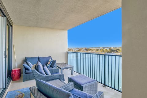 Private patio with outdoor seating overlooking Old River at Wind Drift Orange Beach Bayfront vacation rental condo