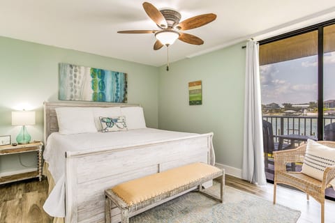 Primary bedroom with king bed and stunning Old River views at Wind Drift Orange Beach bayfront vacation condo