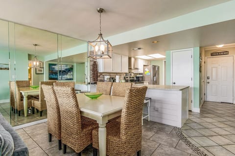 Dining table with natural light and bay views at Wind Drift Bayside N Orange Beach waterfront condo rental