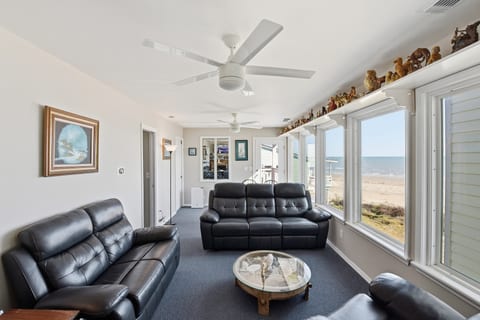 Bright beachside lounge with panoramic ocean views and plush seating.