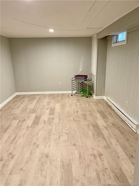 Bright flex room with wood-look floors and recessed lighting