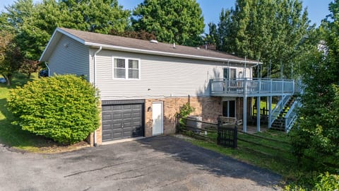 Spacious home with private driveway, garage, and large elevated deck