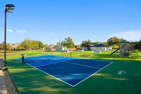 Private championship-level pickleball court. Playground with play structures for children.
