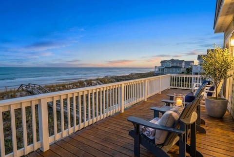 Expansive oceanfront deck at golden hour — premium outdoor living with unobstructed Atlantic panoramas, ideal for sunset cocktails and elegant entertaining