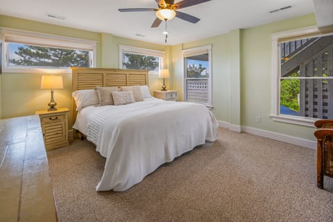 King bedroom with modern appointments — clean lines, quality furnishings, and sophisticated coastal style throughout