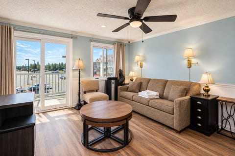 Enjoy the mountain views from the comfort of this living room with balcony access.