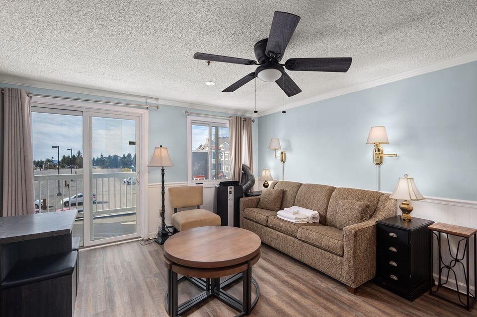 Enjoy the mountain views from the comfort of this living room with balcony access.