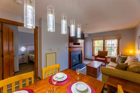 Enjoy a cozy meal by the fireplace in this inviting dining room!