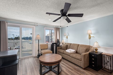 Enjoy the mountain views from the comfort of this living room with balcony access.
