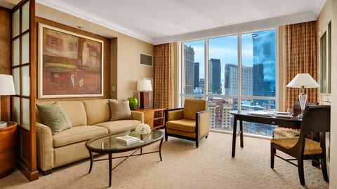 Unwind in style with a comfortable seating area and floor-to-ceiling windows showcasing stunning city views.