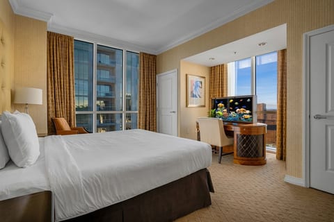 King Suite — Studio residence king bed with floor-to-ceiling windows and high-floor Las Vegas skyline views