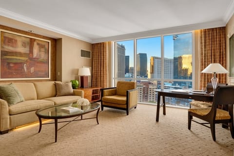City Skyline View — Studio Suite living area with king bed, seating zone, and Las Vegas skyline backdrop