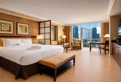 King Suite — 32nd Floor primary bedroom with private ensuite bath, blackout drapes, and open city views