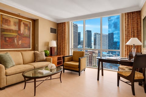 City Skyline View — Studio Suite living area with king bed, seating zone, and Las Vegas skyline backdrop