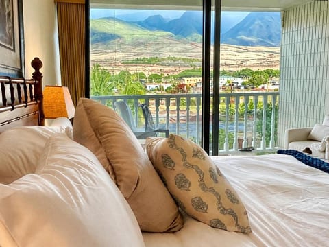 Wake to West Maui Mountains framed by floor-to-ceiling windows. Natural light floods this space, perfect for creative work with an inspiring backdrop. Premium bedding, queen mattress, wood carved bed, high quality tract blackout shade.