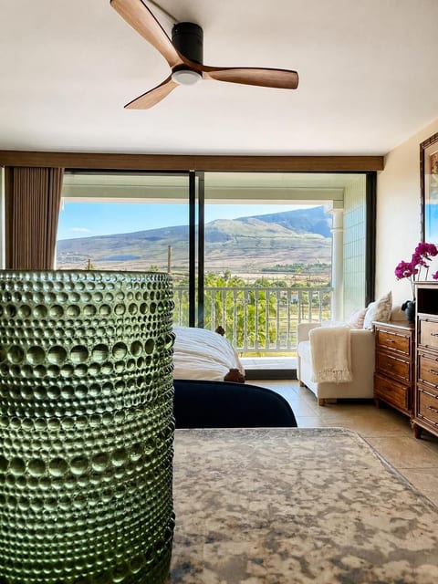 It’s hard to miss the view here. From kitchen facing the west Maui mountains. French blue style drinking glass. The cream colored armchair converts to a twin bed (Serta branded).
