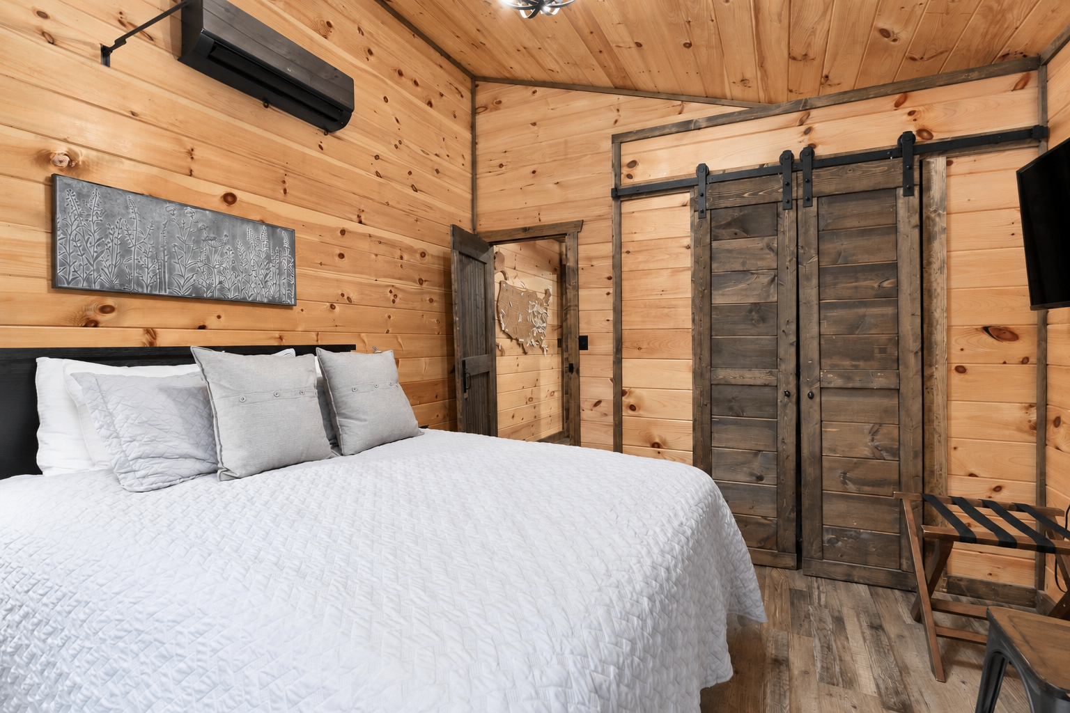 Queen bedroom with Roku TV, blackout curtains, workspace and printer.