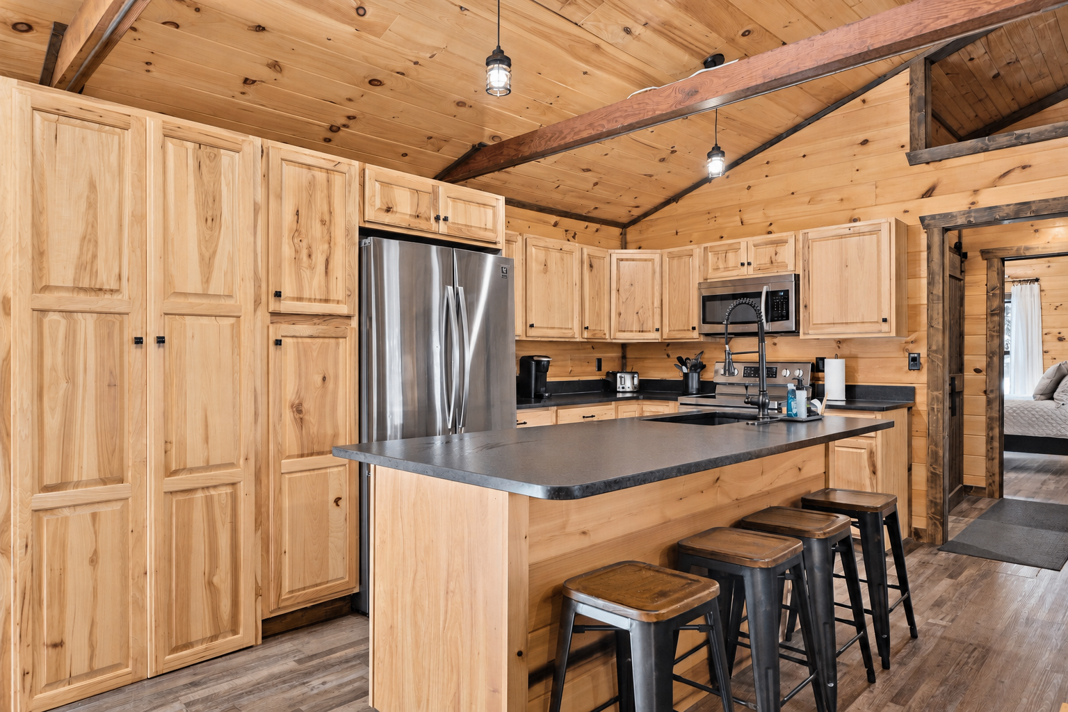 Fully equipped kitchen with dishwasher, coffee station and island seating for four.